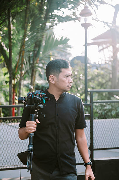 istock Photographer holding camera with stabilizer, outdoors portrait 2238293075
