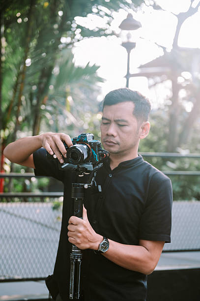 istock Photographer Adjusting Camera on Gimbal for Shoot 2238293085