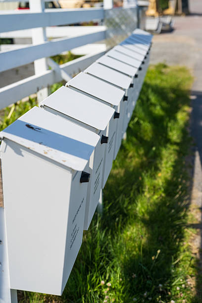 istock Row of white residential outdoor mailboxes aligned.. 2238295038