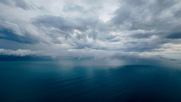 istock Moody seascape with storm clouds and rain over the ocean. 2238295585