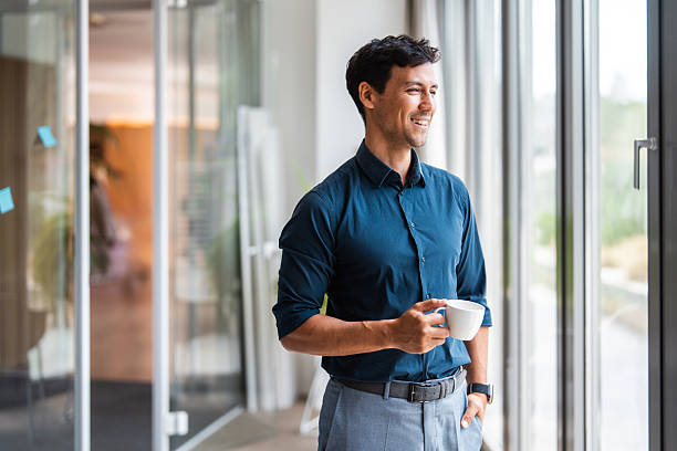 istock Asian Businessman Relaxing with Coffee by Window in Modern Office 2238298451