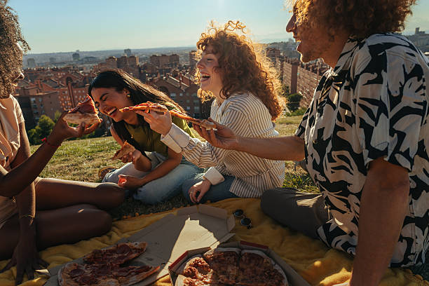 istock Friends eating pizza at sunset during picnic in Madrid 2238299311