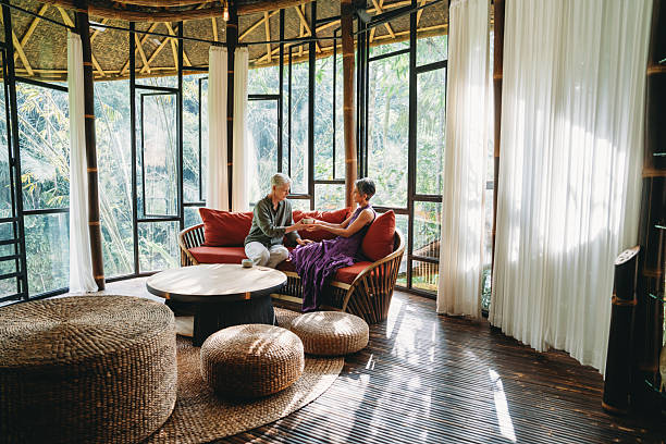 istock Senior couple having tea in bamboo house with jungle view 2238299507