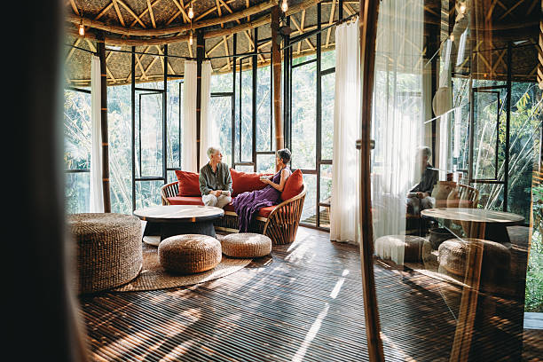 istock Senior couple relaxing in tropical bamboo house 2238299547