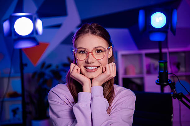 istock Charming young woman in a neon-lit home studio creating media content as a vlogger and influencer 2238299696