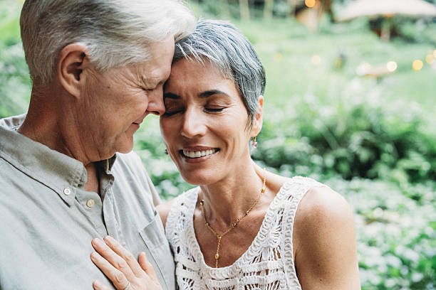 istock Senior couple sharing loving embrace with eyes closed 2238300033