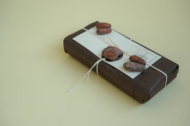 Package of Chocolate Bars in Eco-Friendly Packaging with Sealing Wax. Cocoa Beans. Chocolate Gift. Copy Space. Shallow Depth of Field.
