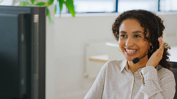istock Woman Wearing Headset Sitting At Desk Working In Office Call Centre Team Taking Call 2238302437