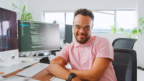 istock Portrait Of Man With Down Syndrome Working In Office Based Business Training To Use Computer 2238302535