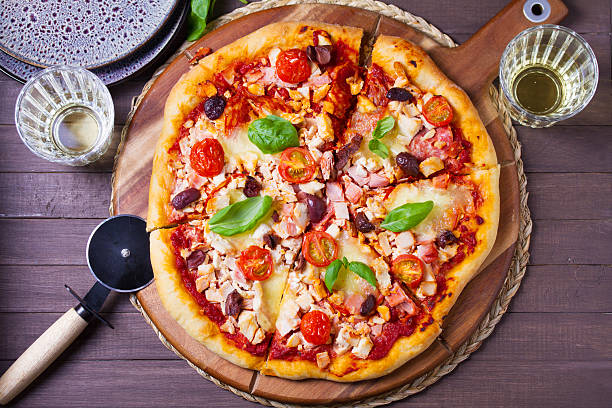 istock Pizza with melted cheese, crispy crust, topped with olives and basil leaves. 2238303700