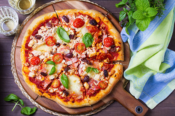 istock Pizza with melted cheese, crispy crust, topped with olives and basil leaves. 2238304268