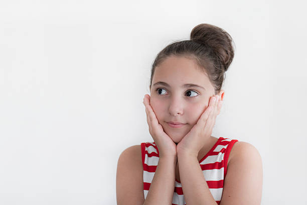 Cute little girl thinking on white background