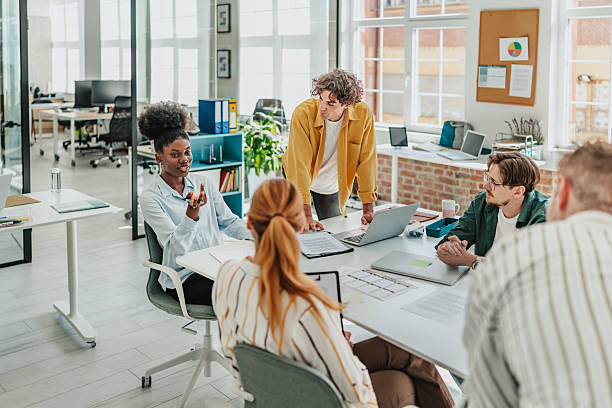 istock Young adults collaborate in a modern office environment, engaging in productive teamwork and discussion during a meeting 2238305308
