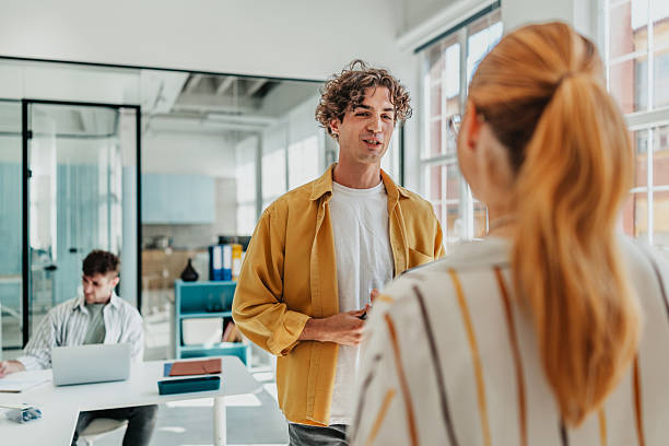 istock Young adults engage in a collaborative discussion in a modern office environment during the workday 2238305670