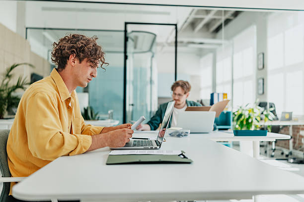 istock Young people work together in a modern office space while enjoying technology and collaboration 2238307242