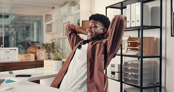 istock Happy, black man or stretching with completion for done, productivity or deadline success in office. Male person, relax or administrator with smile or break for finished tasks or company agenda 2238308517