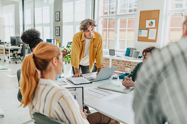 istock Young professionals collaborate in a modern office during a meeting to discuss project progress and strategies 2238308560