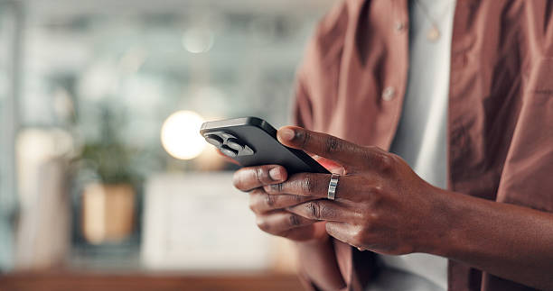 istock Cellphone, hands and man in office with networking, communication or contact on mobile app. Typing, technology and African male creative director with chatting online with phone in workplace. 2238308607