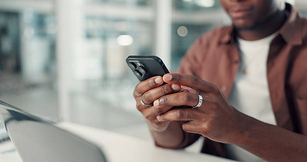 istock Phone, hands and black man in office with networking, communication or contact on mobile app. Typing, technology and African male creative director with chatting, online and cellphone in workplace. 2238308628