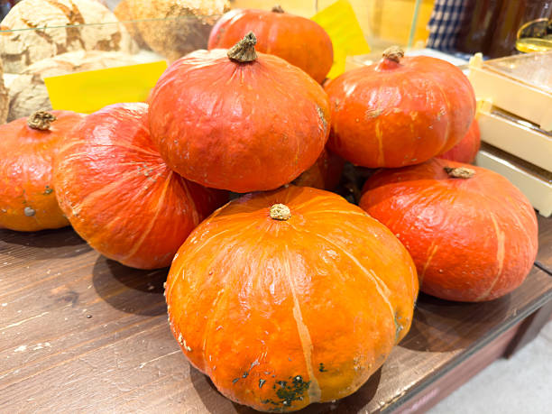 Fresh orange pumpkins displayed on wooden table