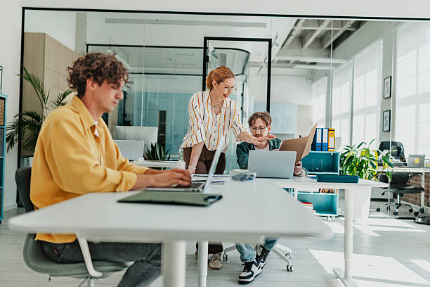 istock Young professionals collaborate in a modern office space while enjoying teamwork and technology 2238309297