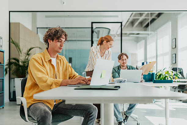 istock Young professionals collaborating and engaging in a modern office environment during the afternoon 2238309421