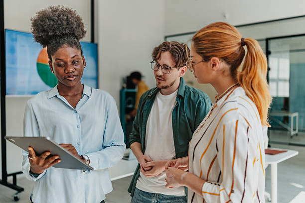 istock Young professionals collaborating in a modern office environment to discuss project insights and enhance teamwork 2238309594