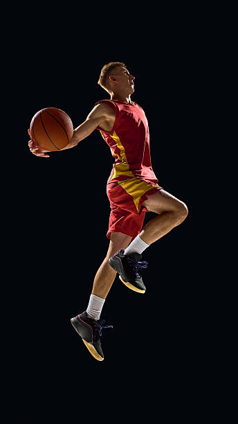 istock Basketball player preparing powerful dunk with intensity on dark court 2238310376