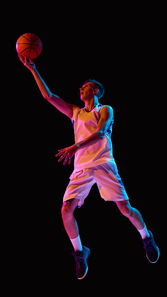 istock Basketball player reaching for layup in neon lights with determination 2238310391