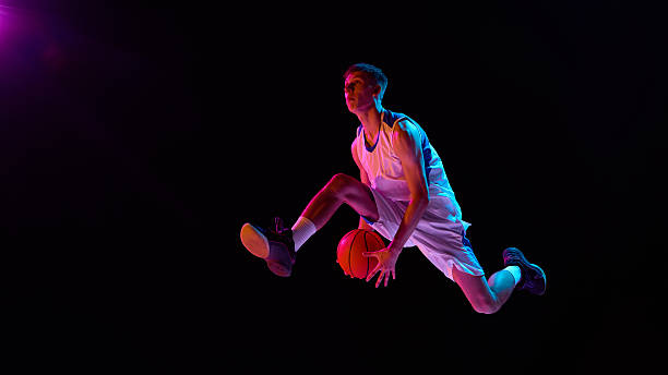 istock Basketball player flying mid air neon lights action and emotion 2238310392