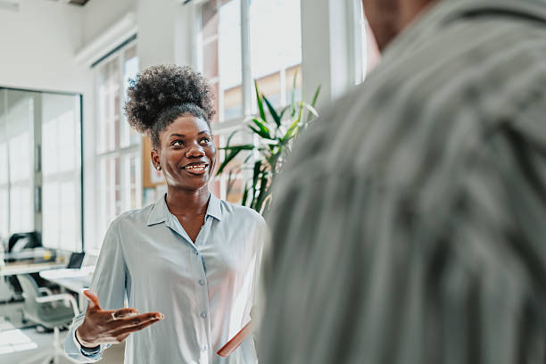 istock Young professionals engage in meaningful conversation at a modern office environment 2238311866