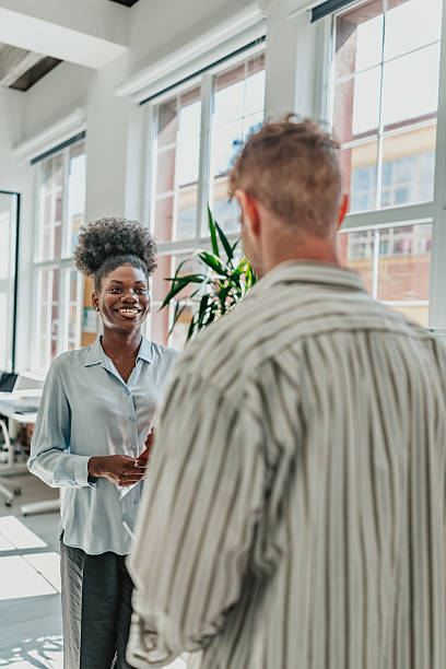 istock Young professionals engage in productive conversation in a modern office environment 2238312235