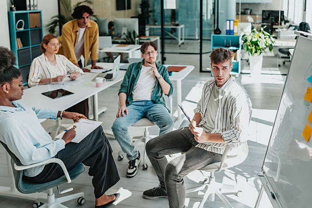 istock Young professionals engage in productive team meeting at modern office space 2238312254
