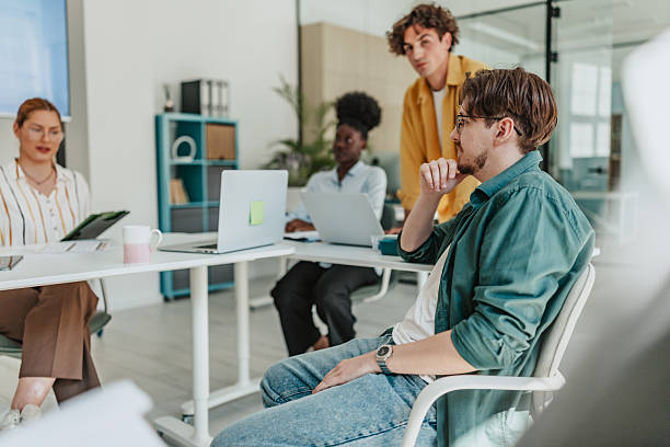 istock Young professionals engage in teamwork and collaboration during a business meeting at a modern office 2238312306