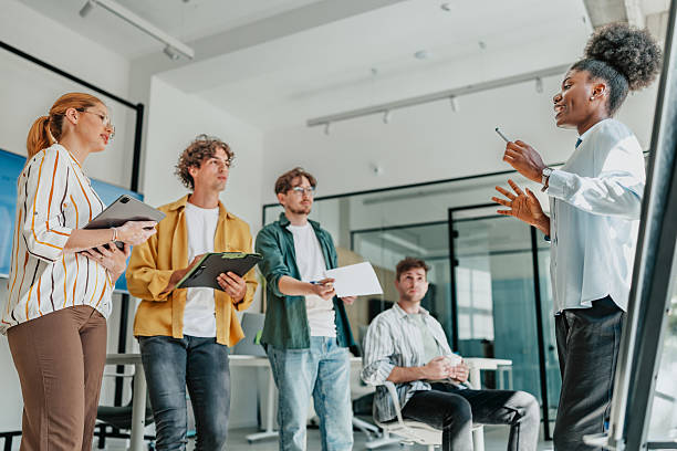 istock Young professionals engaged in collaborative discussion in a modern office setting 2238313063
