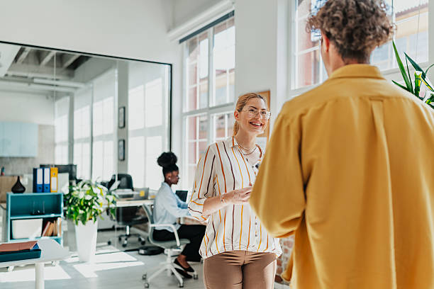 istock Young professionals engaged in lively conversation in a modern office environment fostering teamwork and communication 2238313145