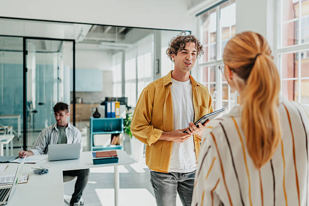 istock Young professionals engaged in lively discussion and collaboration in a modern office setting 2238313172