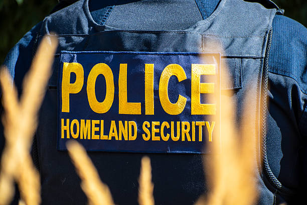 Provo, Utah, USA – September 15, 2025: Back view of a tactical vest labeled ‘Police Homeland Security’ worn by a law enforcement officer in an outdoor area.