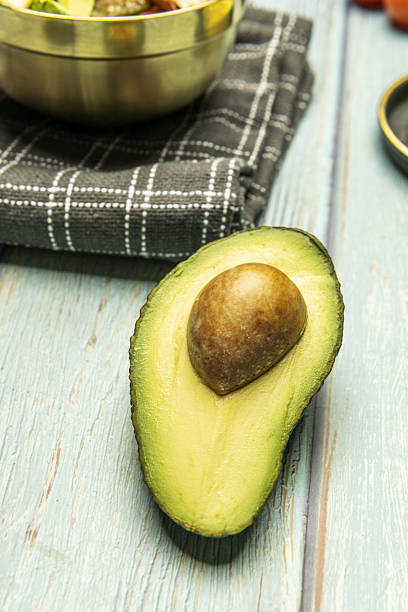 istock A ripe super avocado cut in half on a light blue table 2238316801