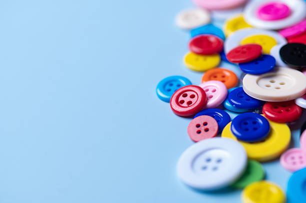 Colorful Assortment of Sewing Buttons on Blue Background