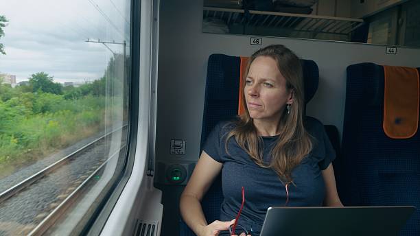 istock Woman traveling by train work on her laptop 2238317523