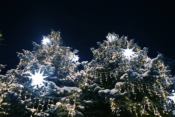 Christmas tree decorated with garland and glowing ornaments