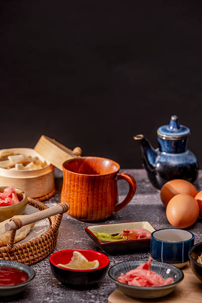 istock Various bowls with condiments, jars, wooden cups and sauces on a gray stone table 2238322650