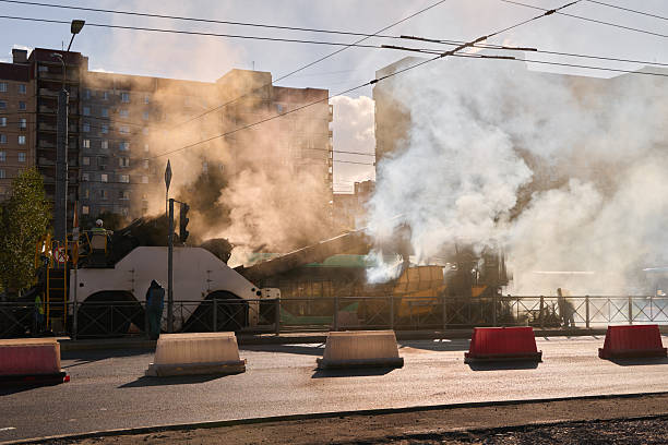 istock Smoke is Rising Steadily from an Urban Setting Surrounded by Various Buildings and Structures 2238323415
