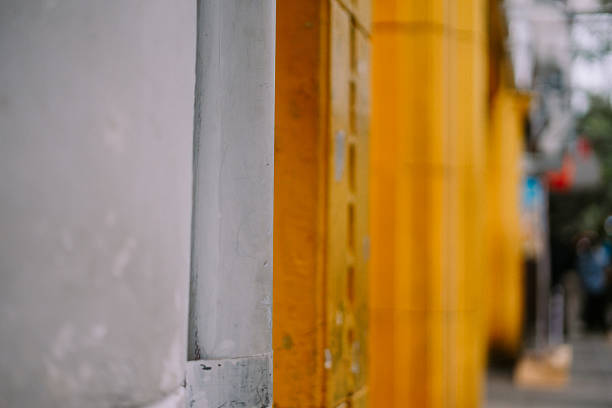 Close-up shot of a yellow building facade with a unique, abstract perspective, offering a modern architectural design element.