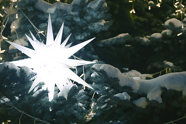 Christmas tree decorated with garland and glowing ornaments