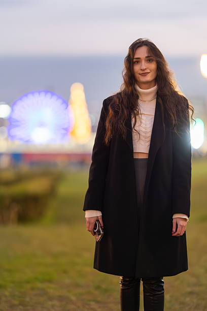 istock Young woman enjoying an evening at amusement park 2238329685