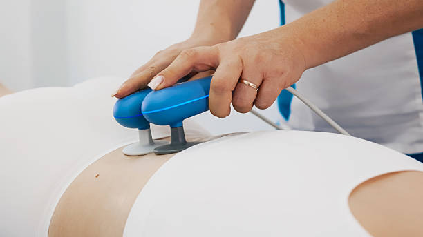istock Physiotherapist using TR-THERAPY medical equipment for effective pain relief. 2238330016