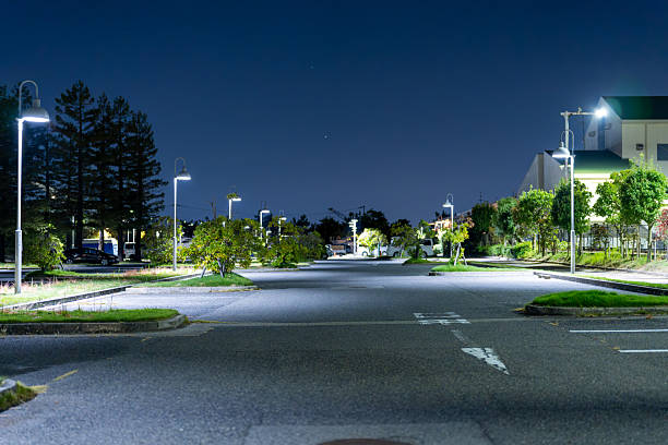 istock Quiet Tree-Lined Street at Night with Warm Streetlights 2238333969