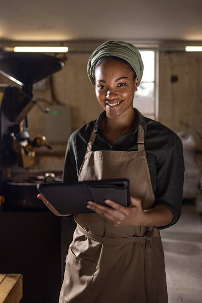 istock Smiling Small Business Owner Holding Tablet in Cozy Cafe Environment 2238334105